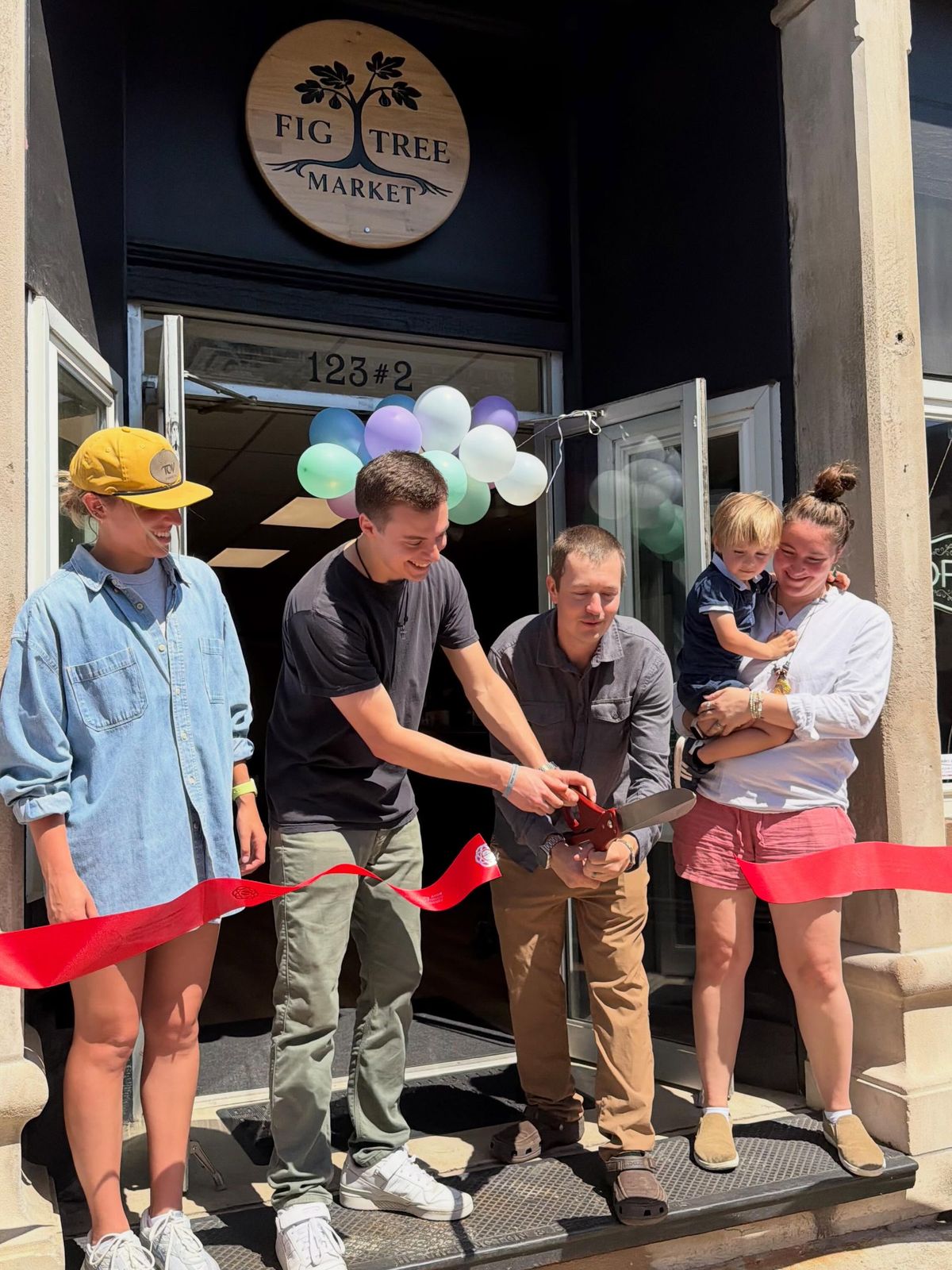The ribbon cutting on opening day at Fig Tree Market
